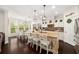 Spacious kitchen with a large island, granite countertops, and an adjacent dining area with bright windows at 2921 Terra View Sw Dr, Lilburn, GA 30047