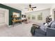 Cozy living room with a green accent wall, comfortable seating, and ample natural light from the windows at 2921 Terra View Sw Dr, Lilburn, GA 30047