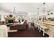 Open-concept living space with fireplace, bar seating and dark hardwood floors at 2921 Terra View Sw Dr, Lilburn, GA 30047