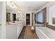 Luxurious main bathroom with double vanity, soaking tub, and walk-in closet at 2921 Terra View Sw Dr, Lilburn, GA 30047