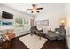 Well-lit home office featuring hardwood flooring, ceiling fan, and large window at 2921 Terra View Sw Dr, Lilburn, GA 30047