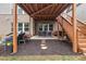 Outdoor patio with stylish seating beneath a covered deck and stairs at 2921 Terra View Sw Dr, Lilburn, GA 30047