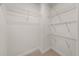 Uncluttered walk-in closet with minimal shelving offering customization for storage solutions at 2921 Terra View Sw Dr, Lilburn, GA 30047