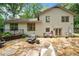 Home's backyard with stone patio, seating and manicured landscaping at 3252 Custer Lake Drive Northwest Nw Dr, Marietta, GA 30064