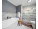 Bright bathroom featuring a modern soaking tub and a glass enclosed shower with tiled walls at 3252 Custer Lake Drive Northwest Nw Dr, Marietta, GA 30064