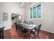 Bright dining room featuring a wood table, black chairs, a high ceiling with a modern light fixture, and hardwood floors at 3252 Custer Lake Drive Northwest Nw Dr, Marietta, GA 30064