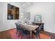 Bright dining room featuring a wood table, black chairs, a high ceiling with a modern light fixture, and hardwood floors at 3252 Custer Lake Drive Northwest Nw Dr, Marietta, GA 30064