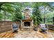 Stone outdoor fireplace with comfortable seating area for relaxation and entertaining at 3252 Custer Lake Drive Northwest Nw Dr, Marietta, GA 30064