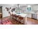 Bright kitchen with white cabinets, stainless appliances, a large island with seating, and a unique world map wall decoration at 3252 Custer Lake Drive Northwest Nw Dr, Marietta, GA 30064