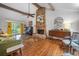 Cozy living room featuring a brick fireplace, high ceilings with wood beams, and comfortable seating, creating a warm atmosphere at 3252 Custer Lake Drive Northwest Nw Dr, Marietta, GA 30064