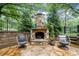 Outdoor stone fireplace with seating on a stone patio at 3252 Custer Lake Drive Northwest Nw Dr, Marietta, GA 30064
