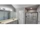 Bathroom with dual vanity, neutral paint, light fixtures and glass enclosed shower at 1230 Chris Lake Dr, Lawrenceville, GA 30046