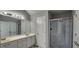 Bathroom with dual vanity, neutral paint, light fixtures and glass enclosed shower at 1230 Chris Lake Dr, Lawrenceville, GA 30046