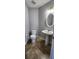 Half bathroom features a pedestal sink, tile floor and light fixtures at 1230 Chris Lake Dr, Lawrenceville, GA 30046