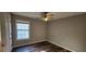 Bright bedroom with hardwood floors, window and neutral paint at 1230 Chris Lake Dr, Lawrenceville, GA 30046