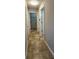 Hallway with doors leading to storage and rooms with tile flooring for easy cleaning at 1230 Chris Lake Dr, Lawrenceville, GA 30046