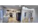 Well-lit kitchen with stainless steel appliances and white cabinets with an open view to the foyer at 1230 Chris Lake Dr, Lawrenceville, GA 30046