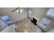Bright living room featuring a fireplace, multiple windows, and view of ceiling fan at 1230 Chris Lake Dr, Lawrenceville, GA 30046