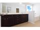 Bathroom featuring dark cabinets, double sinks, a separate tub and glass shower at 315 Lakeside Ln, Woodstock, GA 30188