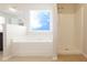 Bathroom featuring a soaking tub, tiled floors, and a separate shower at 315 Lakeside Ln, Woodstock, GA 30188