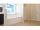 Bathroom features a soaking tub, tiled floors, and a separate shower at 315 Lakeside Ln, Woodstock, GA 30188