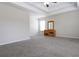 Spacious carpeted bedroom featuring a tray ceiling and a wooden dresser at 315 Lakeside Ln, Woodstock, GA 30188