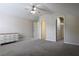 Large bedroom featuring neutral walls, ceiling fan, and walk-in closet at 315 Lakeside Ln, Woodstock, GA 30188