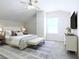 Bedroom featuring a stylish bed, white dresser, ceiling fan and a bright window at 315 Lakeside Ln, Woodstock, GA 30188