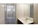 Hallway with a sink, mirror, carpet flooring and a window at the far end of the hall at 315 Lakeside Ln, Woodstock, GA 30188