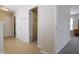 Hallway with tile flooring and access to a closet and carpeted bedroom at 315 Lakeside Ln, Woodstock, GA 30188