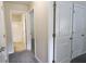 Hallway with neutral walls and carpet leading to rooms and bathroom at 315 Lakeside Ln, Woodstock, GA 30188
