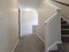 Carpeted hallway with a staircase and access to multiple rooms at 315 Lakeside Ln, Woodstock, GA 30188