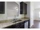 Kitchen featuring granite counters, stainless steel appliances, and dark wood cabinets at 315 Lakeside Ln, Woodstock, GA 30188