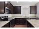 Beautiful kitchen featuring granite countertops and dark cabinets at 315 Lakeside Ln, Woodstock, GA 30188