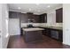 Well-appointed kitchen with dark wood cabinets, granite countertops, and stainless appliances at 315 Lakeside Ln, Woodstock, GA 30188