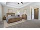 Carpeted main bedroom with a ceiling fan and wood furniture at 315 Lakeside Ln, Woodstock, GA 30188