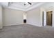 A very large carpeted main bedroom with a tray ceiling and ceiling fan at 315 Lakeside Ln, Woodstock, GA 30188
