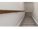Carpeted staircase with wood handrail in a well-lit home at 315 Lakeside Ln, Woodstock, GA 30188