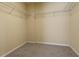 Empty carpeted walk-in closet with wire shelving for ample storage space at 315 Lakeside Ln, Woodstock, GA 30188