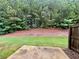 View of backyard with trees and concrete patio at 664 Oakside Pl, Acworth, GA 30102