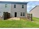 View of back of townhome with fenced-in backyard and small concrete patio at 664 Oakside Pl, Acworth, GA 30102