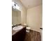 Cozy bathroom with a dark-colored vanity and wood-look flooring at 664 Oakside Pl, Acworth, GA 30102