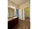 Bathroom featuring double sinks with granite countertops and wood-look flooring at 664 Oakside Pl, Acworth, GA 30102
