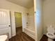 Bright bathroom featuring a bathtub-shower combo and access to a walk-in closet at 664 Oakside Pl, Acworth, GA 30102