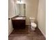Bright bathroom featuring dark vanity and wood-look floors at 664 Oakside Pl, Acworth, GA 30102