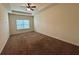 Spacious bedroom featuring a ceiling fan, a window, and neutral colored walls at 664 Oakside Pl, Acworth, GA 30102