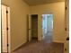 This bedroom provides neutral walls, carpet, a closet, and access to other rooms at 664 Oakside Pl, Acworth, GA 30102