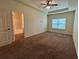 Spacious bedroom featuring a ceiling fan, a window, and neutral walls at 664 Oakside Pl, Acworth, GA 30102