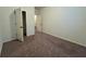 Cozy bedroom featuring neutral walls, carpet, closet, and access to other rooms at 664 Oakside Pl, Acworth, GA 30102