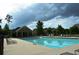 Community pool surrounded by lounge chairs and lush trees, offering a refreshing outdoor amenity at 664 Oakside Pl, Acworth, GA 30102